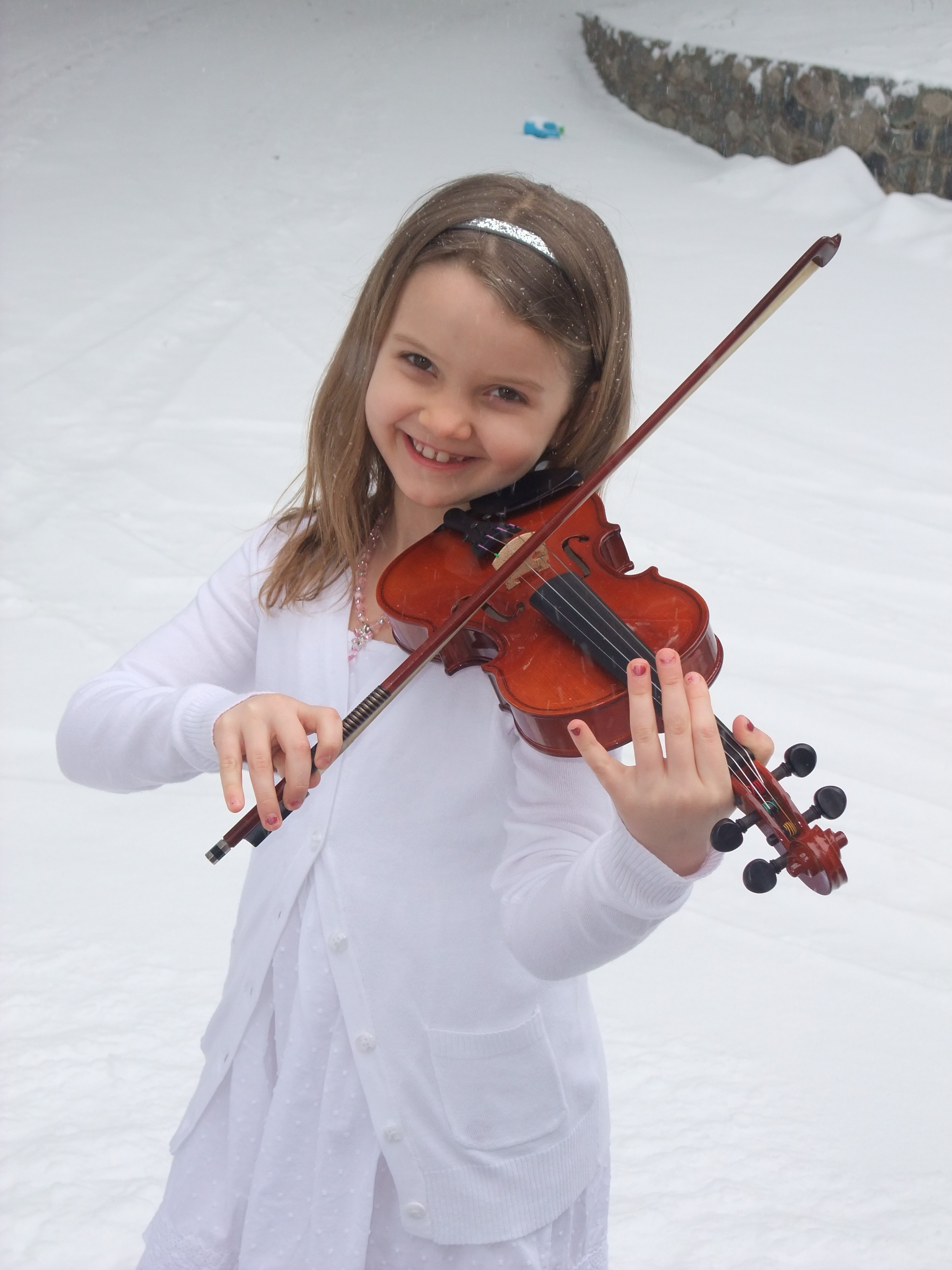 Madelyn playing violin outside in winter