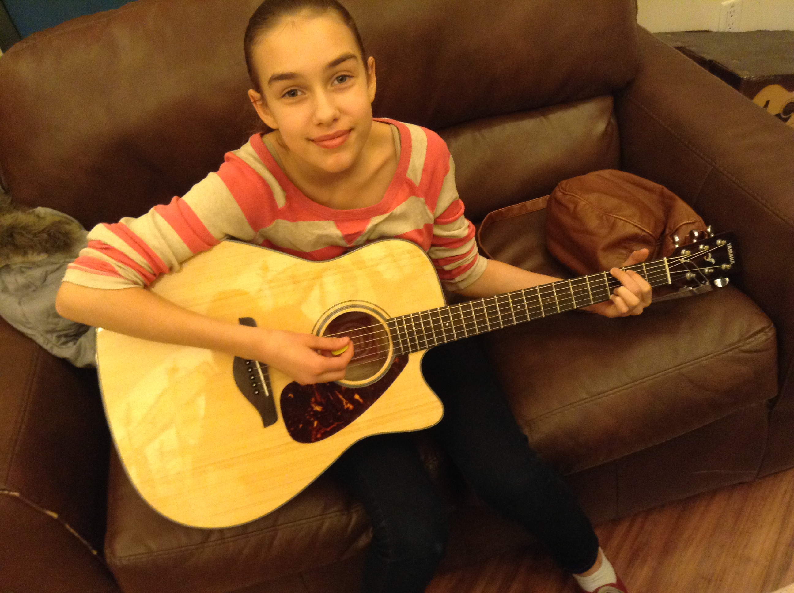 homeschool performance opportunities:  Hannah learning to play guitar