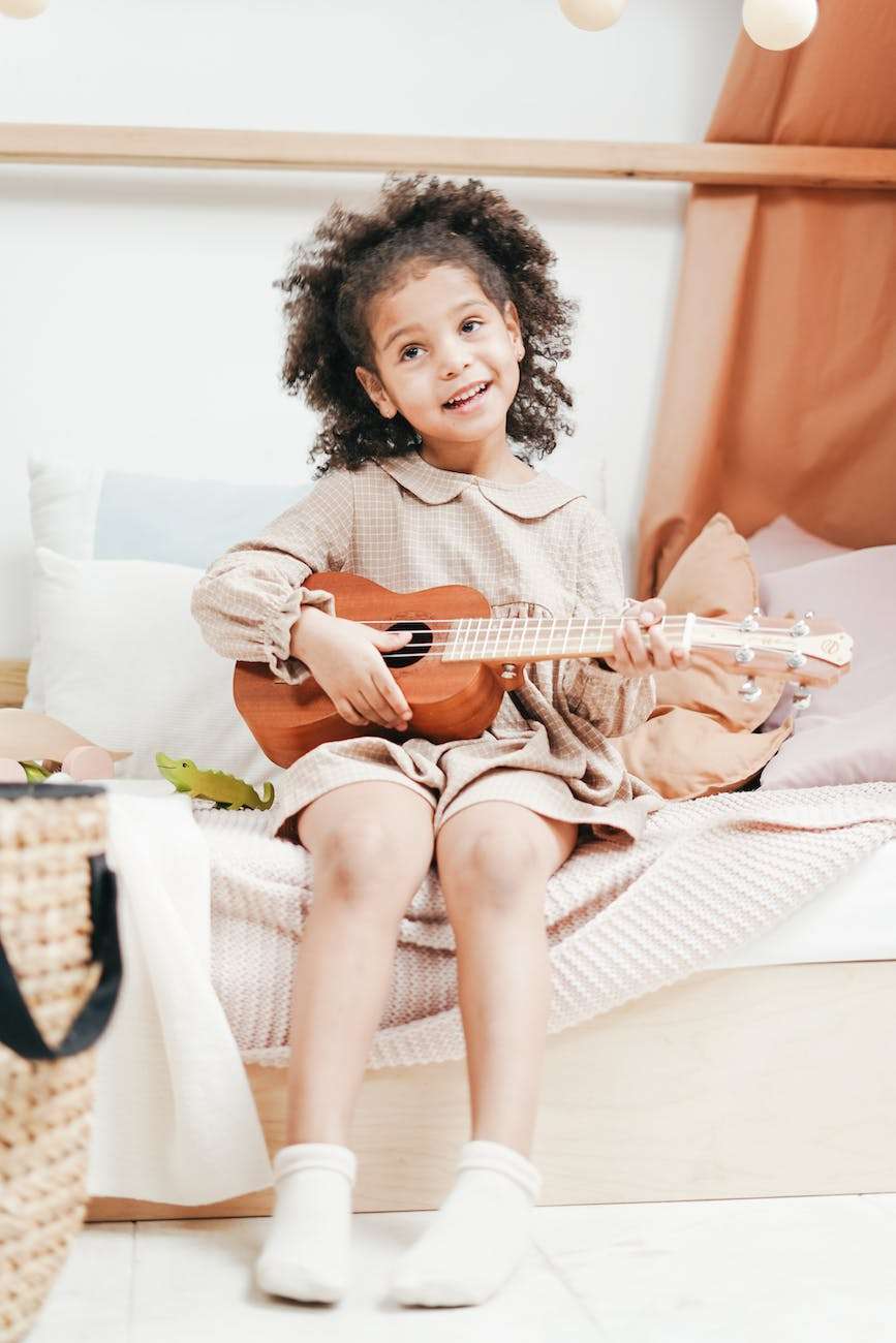 photo of a girl playing ukulele