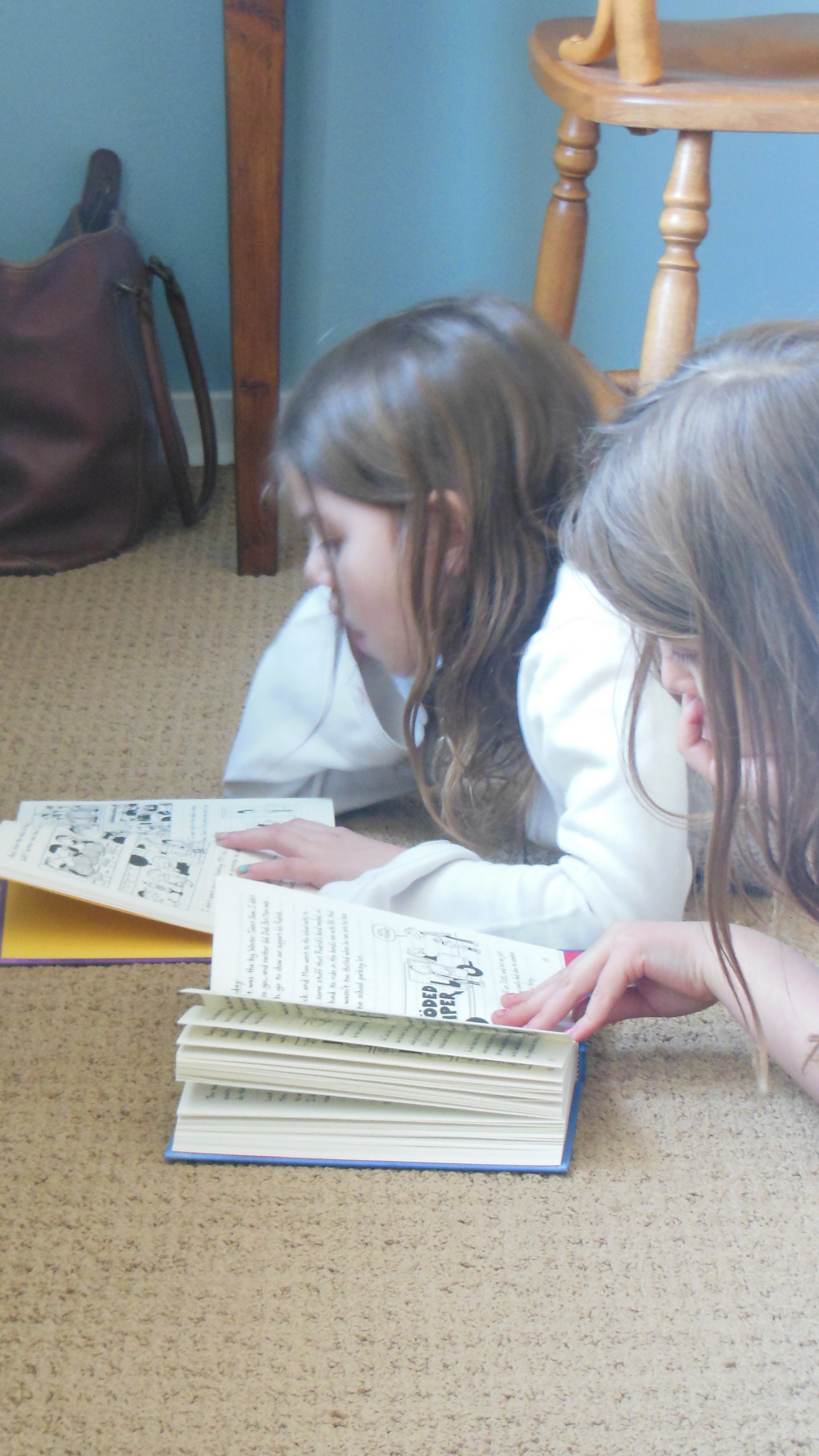 Madelyn Rachel reading on the floor: buy new homeschool curriculum