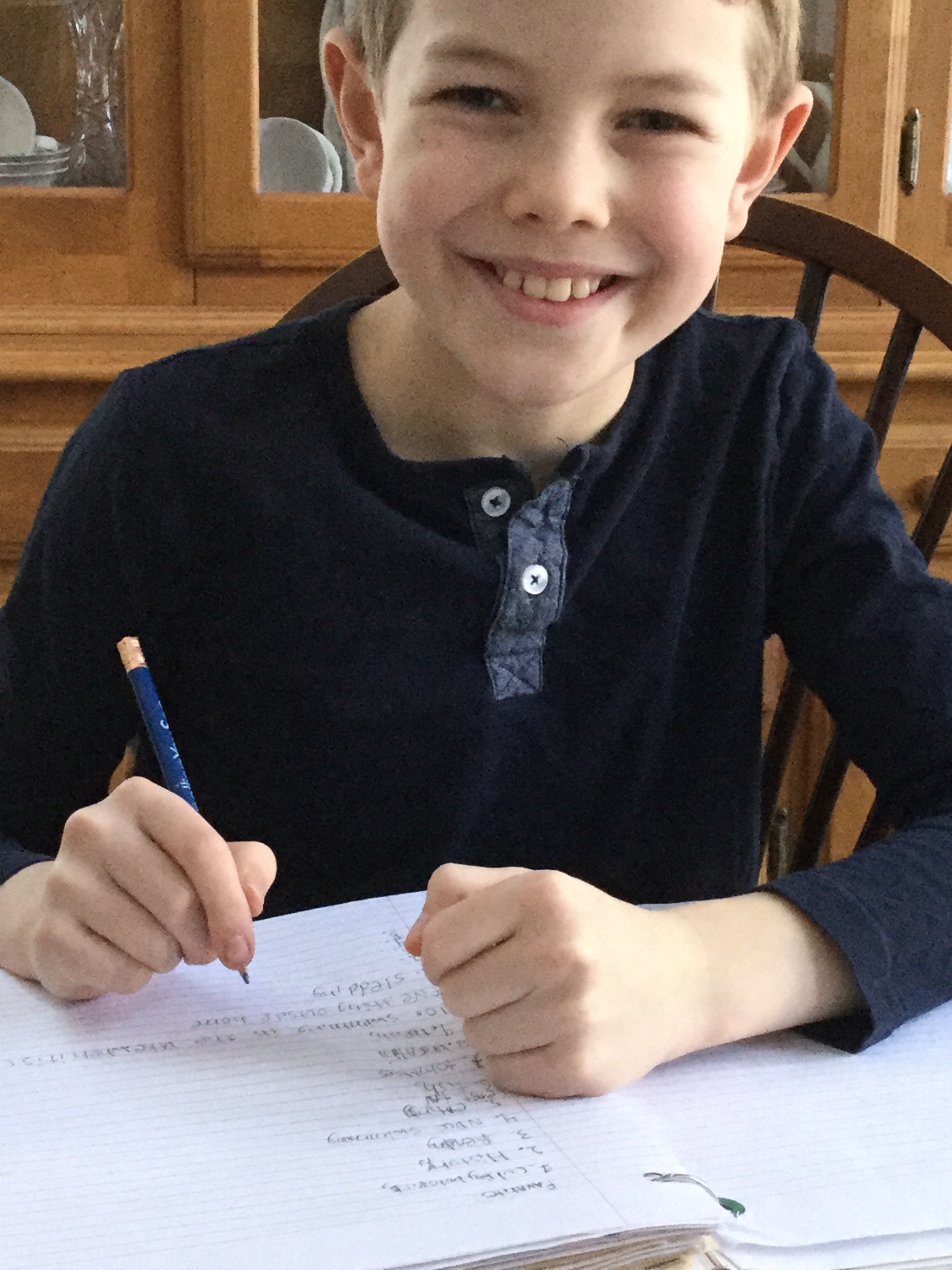 my fourth and only son writing at the kitchen table