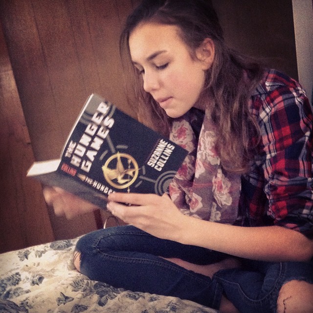 Hannah reading Hunger Games