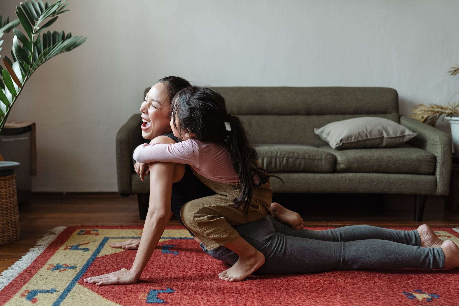photo of girl hugging a woman while doing yoga pose: homeschooling with confidence requires flexibility