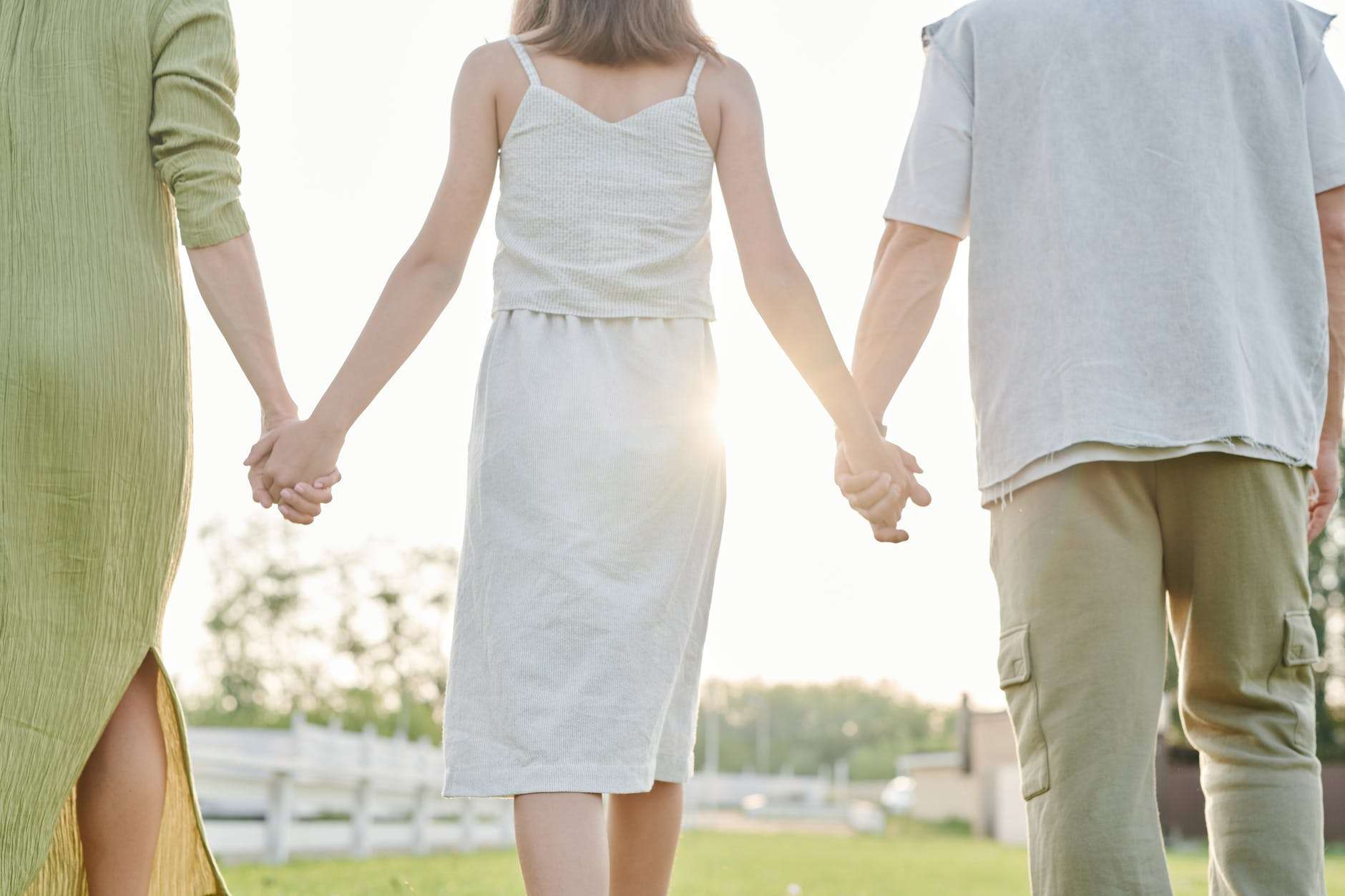 three people walking hand in hand: should i homeschool my child