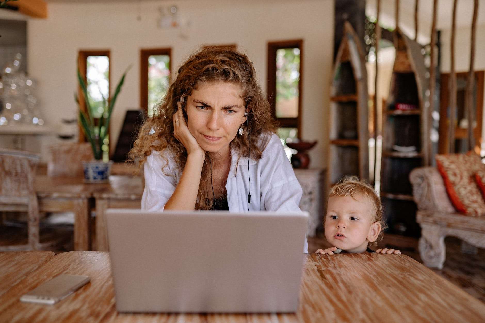 a mother and son looking the laptop and mom not getting quiet and develop boundaries in your homeschool life