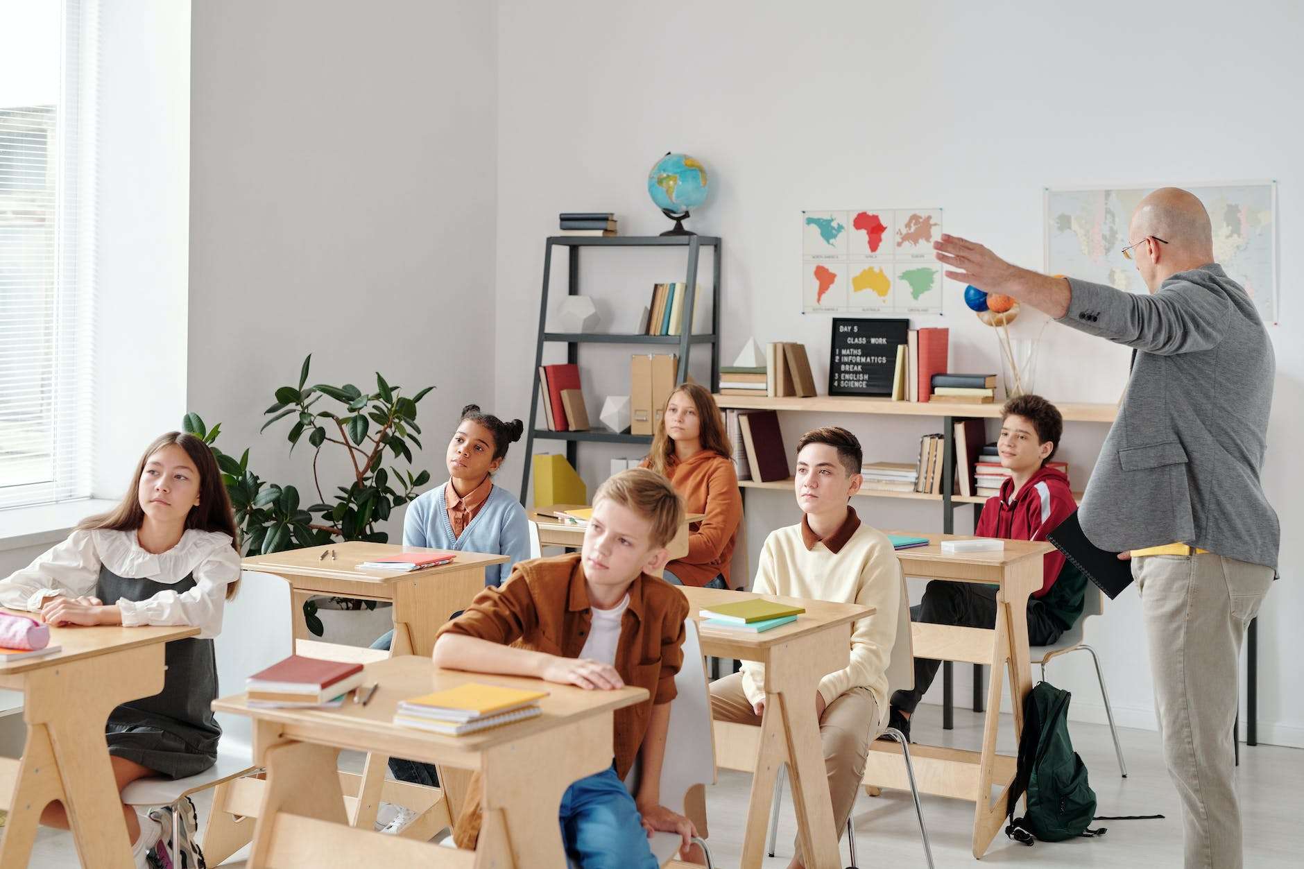 children sitting on chair in front of table: free deschool your homeschool coaching class isn't oing to look like this