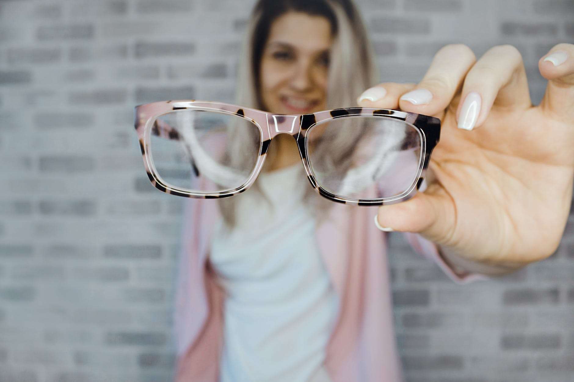 selective focus photography of pink and black framed eyeglasses: