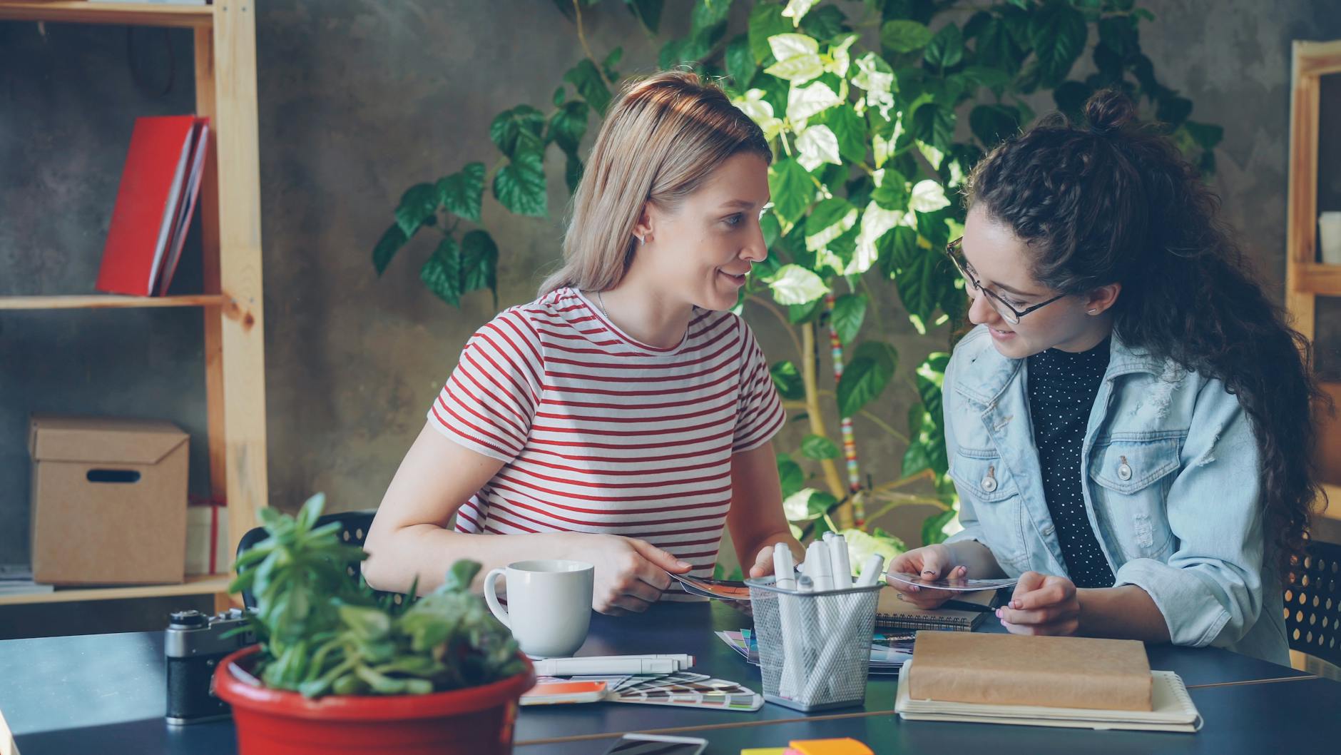 two women collaborating in creative office