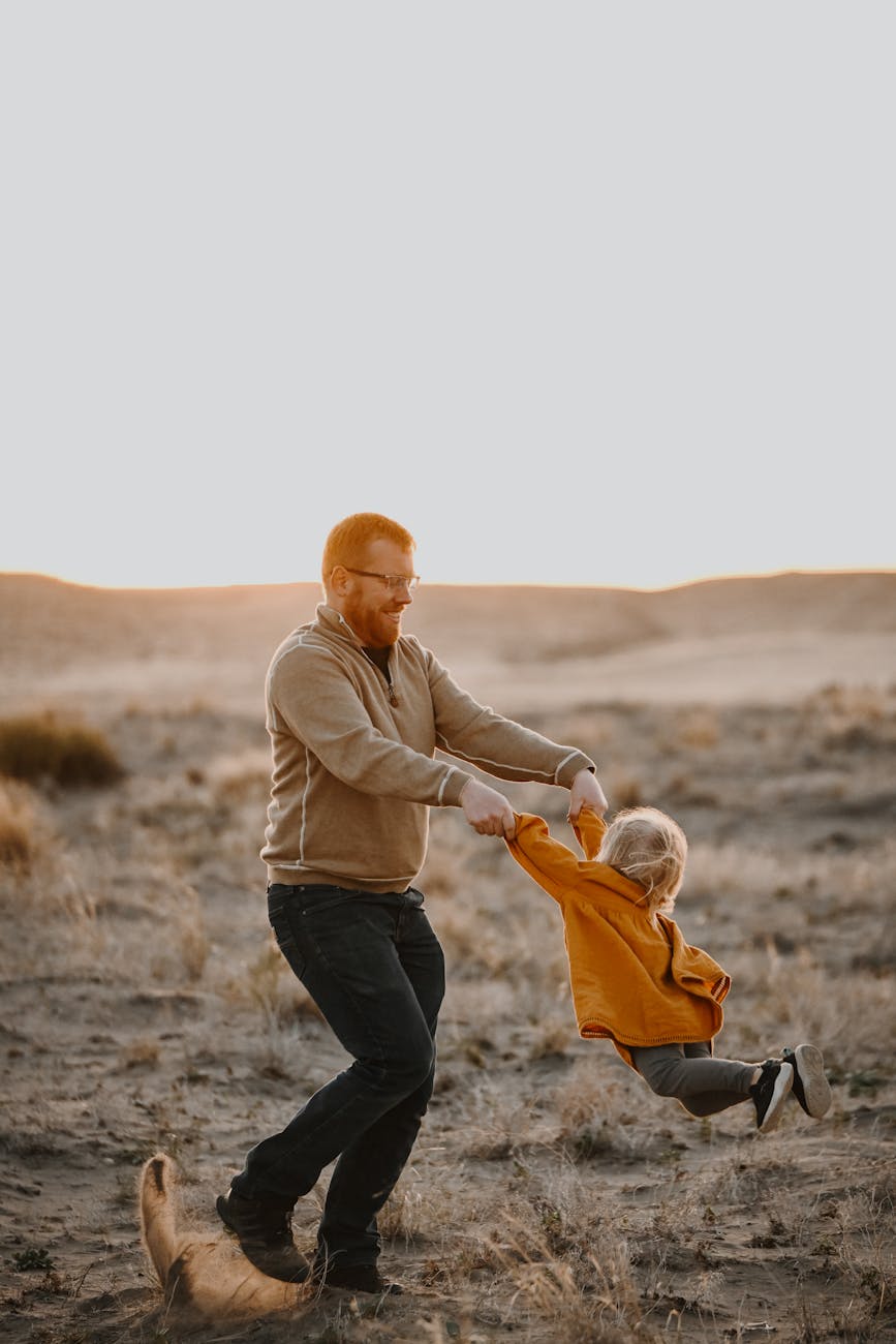 father and child playing outdoors at sunset--5 foundations of a happy homeschool mom