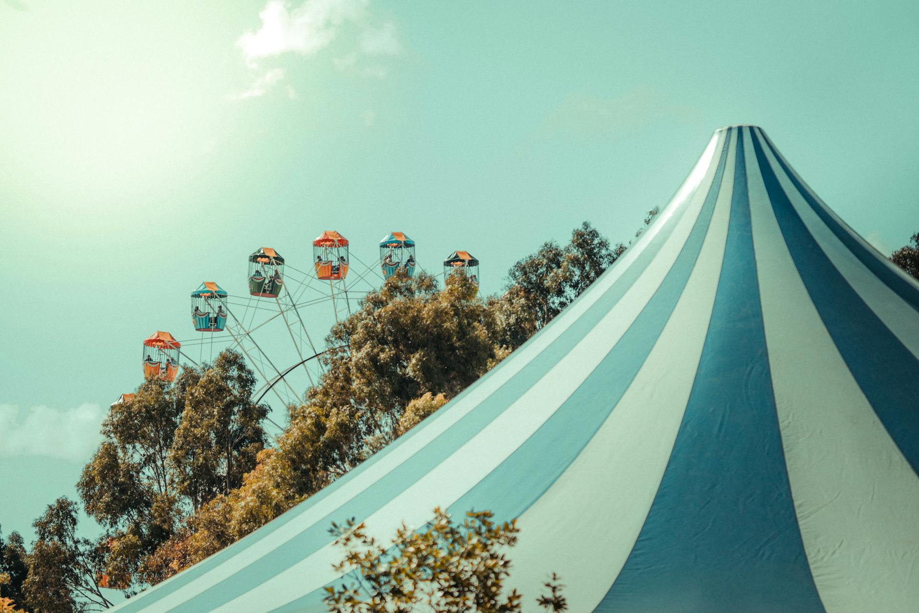 A blue and white striped circus tent — symbolizing the elaborate lengths a perfectionist homeschool mom goes to prove her worth, one handmade birthday party at a time.