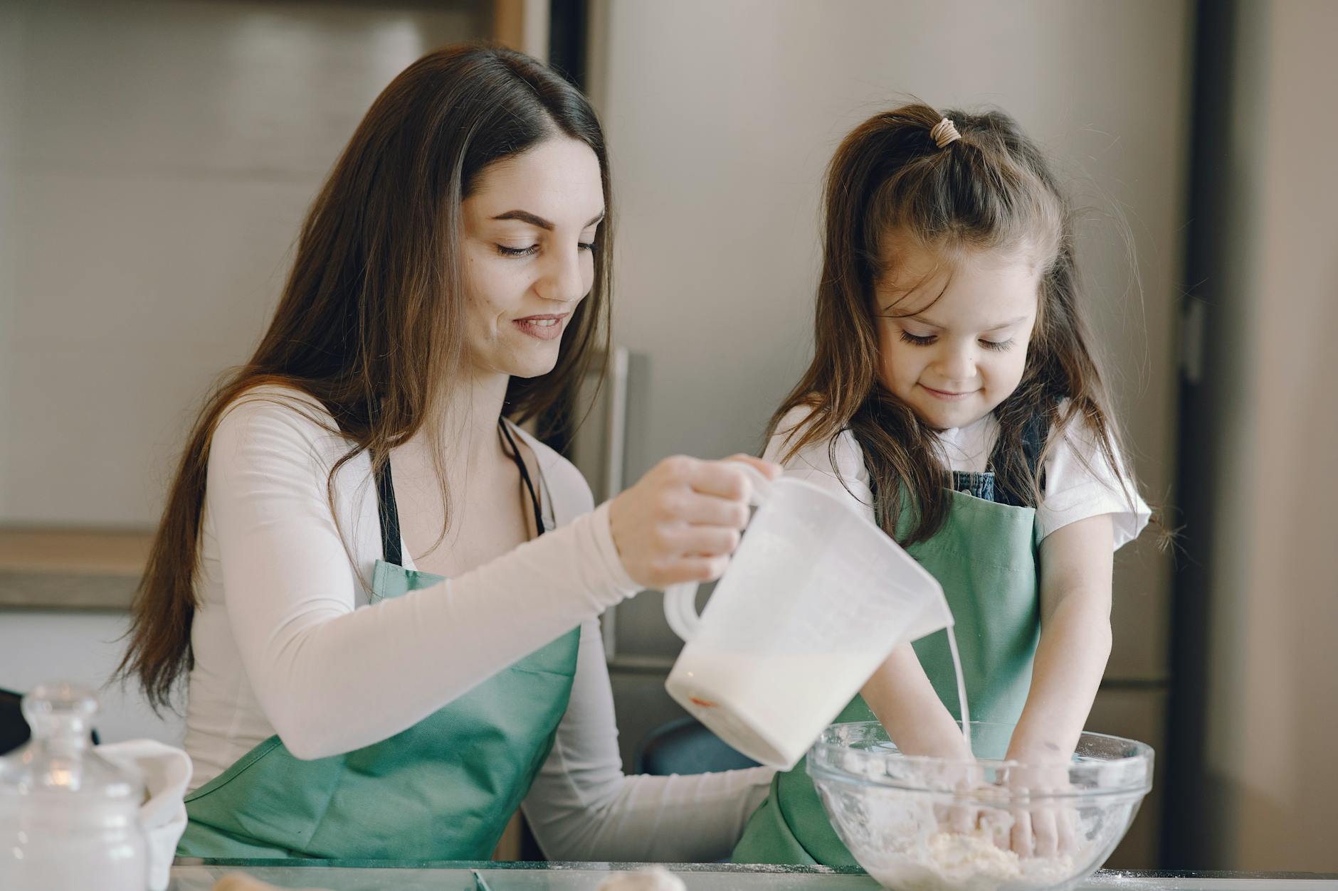 A homeschool mom and her child baking together — a real, messy, joyful moment that perfectionism would have turned into a lesson plan instead of a memory.