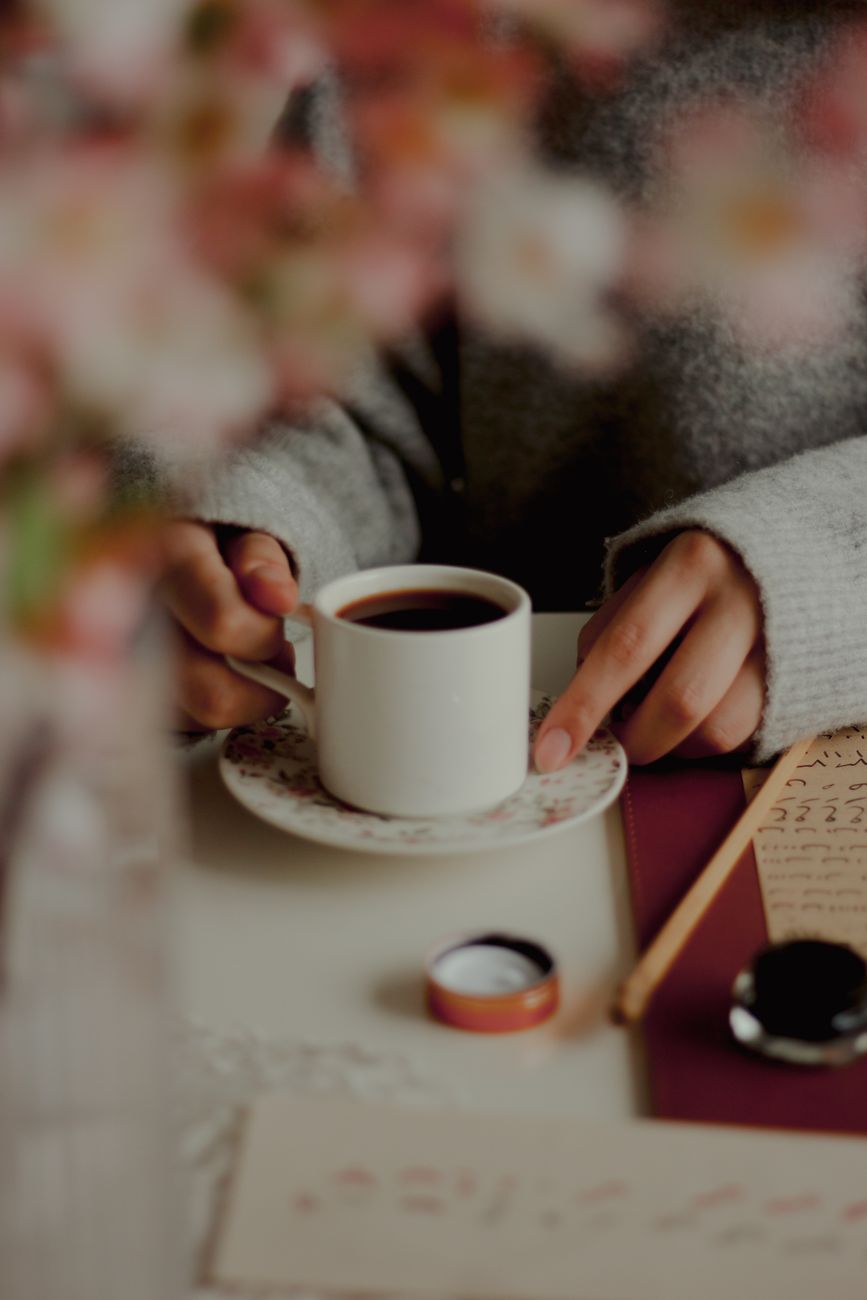 Woman pausing with coffee, giving herself permission to slow down