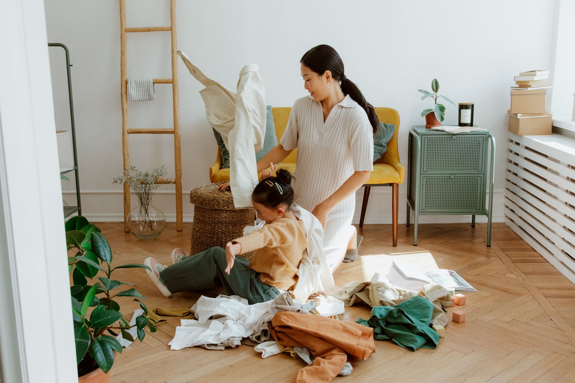 Homeschool mom folding laundry with her daughter, one small step out of decision fatigue and overwhelm